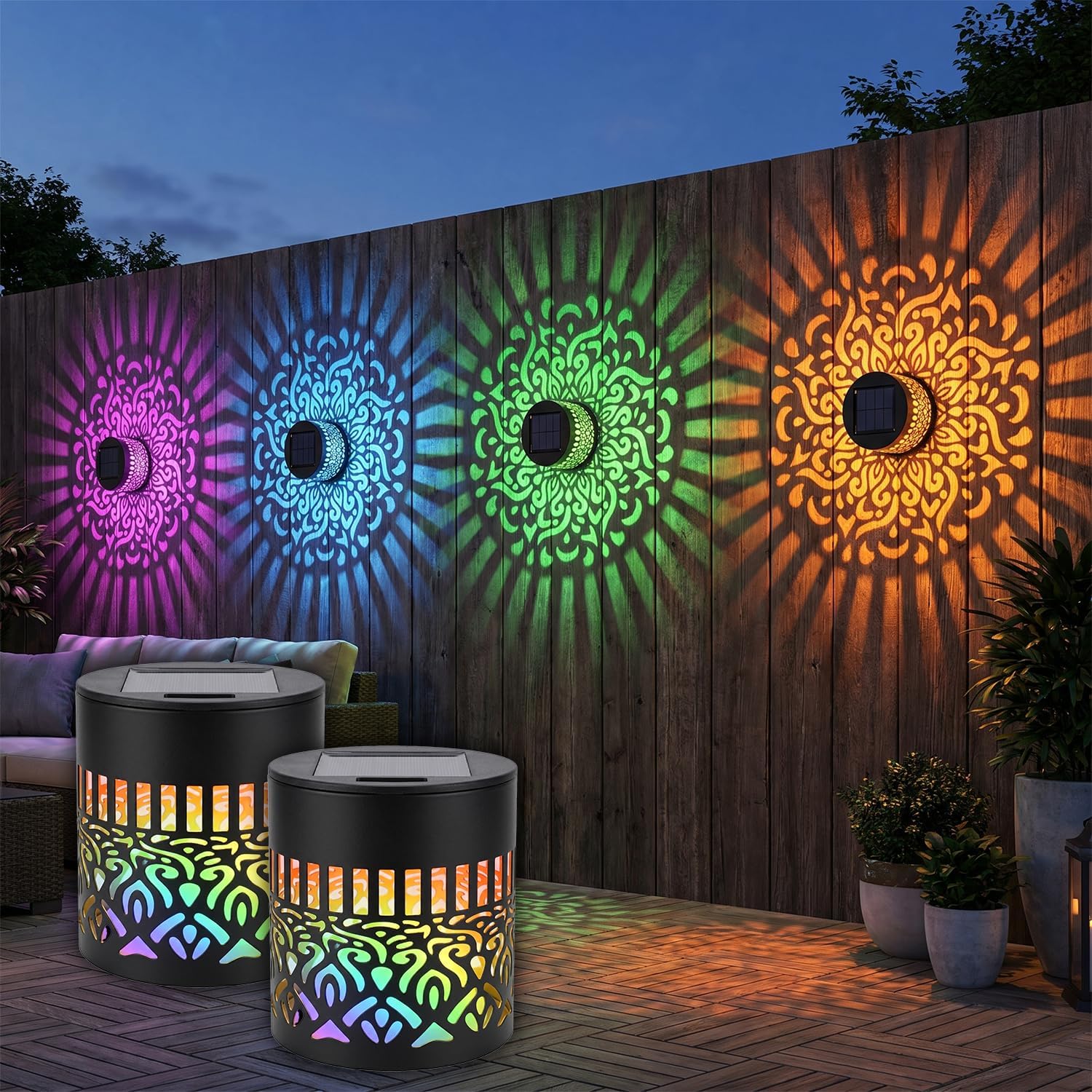 Metal solar mandala wall light projecting a colour-changing pattern onto a fence
